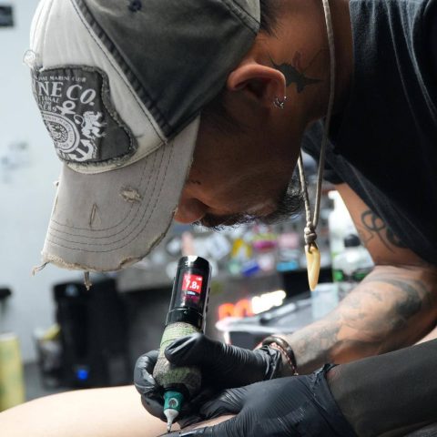 SAE Collective tattoo artist working on a client