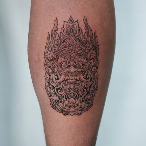Balinese Barong mask tattoo on a calf