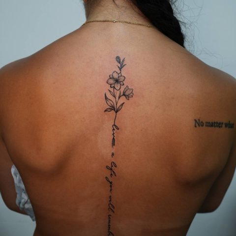Script lettering and florals down a back
