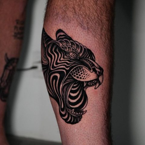 Bold blackwork big cat tattoo